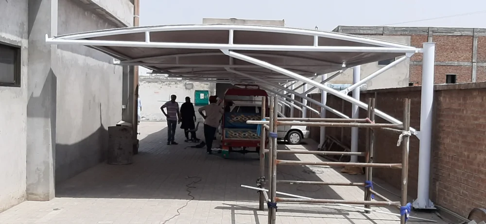 Tensile fabric car parking shades provide durable, weather-resistant protection for vehicles, designed for both residential and commercial use, tailored to the weather conditions of Pakistan.