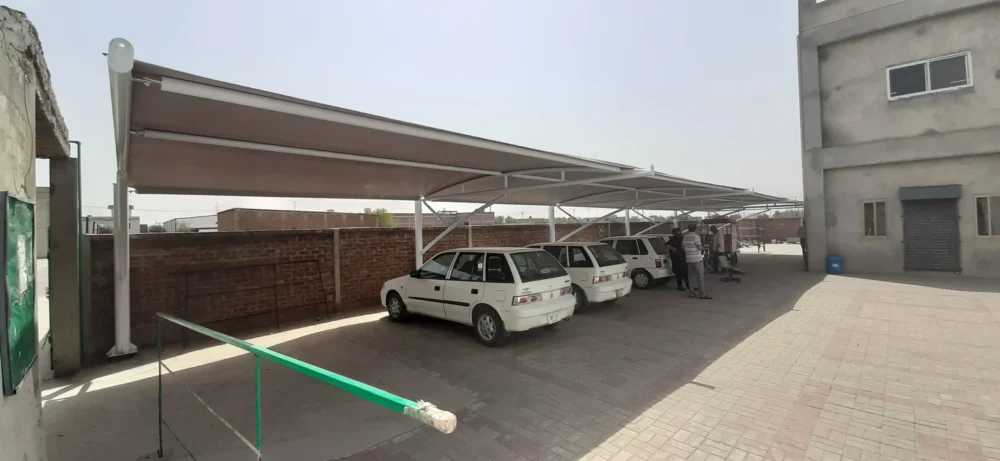 Tensile fabric car parking shades provide durable, weather-resistant protection for vehicles, designed for both residential and commercial use, tailored to the weather conditions of Pakistan.