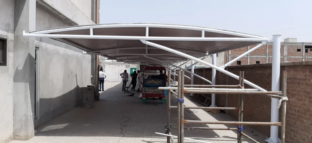 Tensile fabric car parking shades provide durable, weather-resistant protection for vehicles, designed for both residential and commercial use, tailored to the weather conditions of Pakistan.