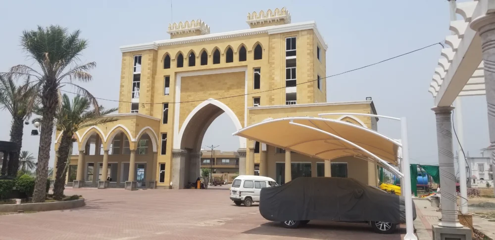 Durable tensile fabric outdoor car parking shade for effective sun and weather protection, ideal for homes and commercial spaces.