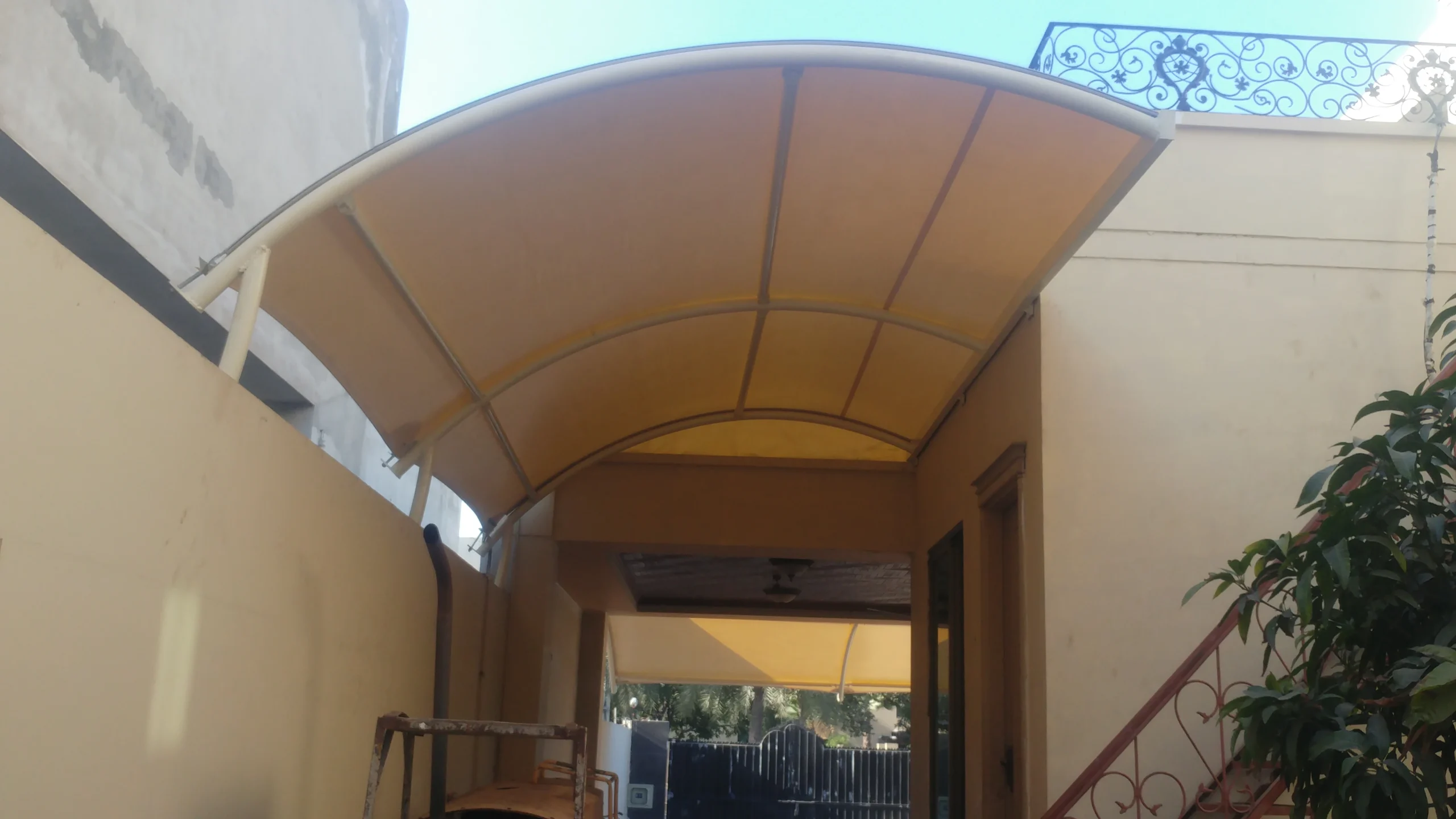 Custom backyard shade canopy offering protection and style for outdoor spaces, perfect for patios, side passages, gardens, and more.