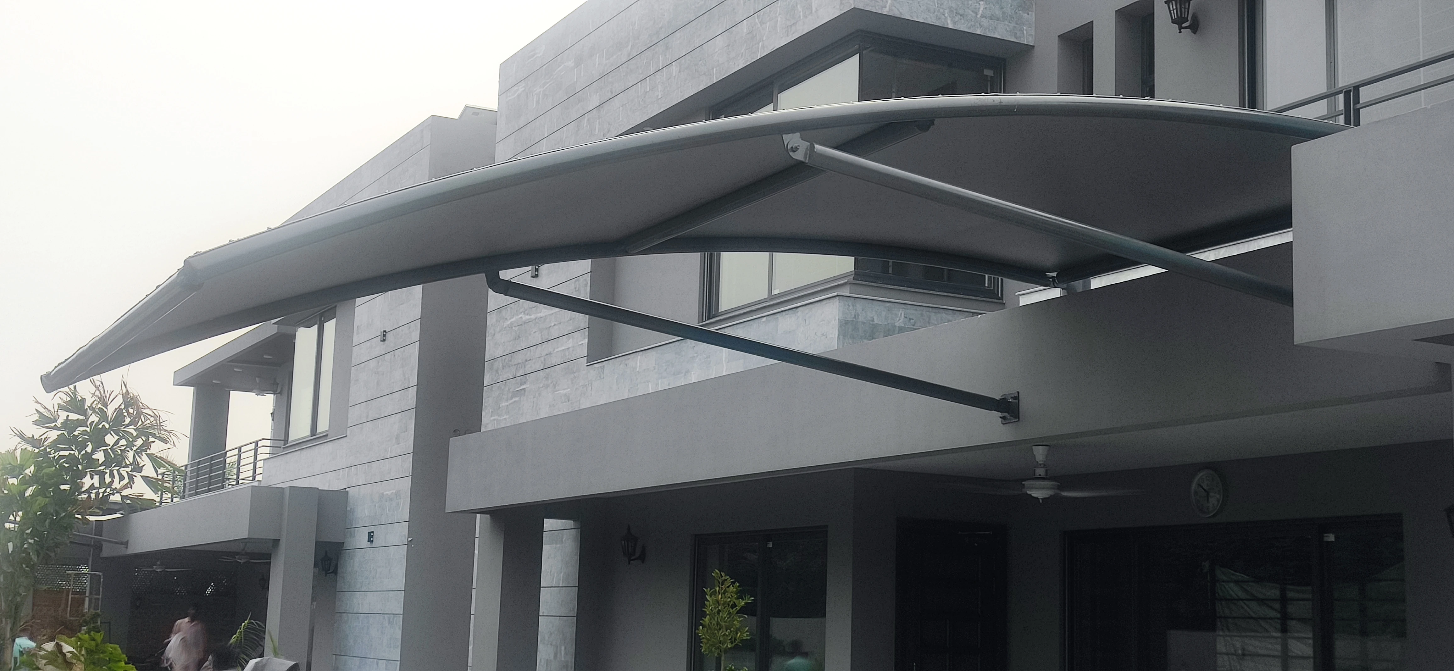 Garage Front Shade Expand Your Parking Space (3) Tensile fabric garage front shade expands the parking space with durable and stylish protection.