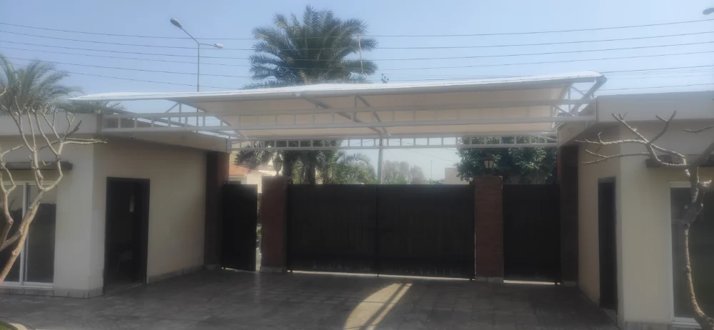 The Gate Entrance Shade is made of tensile fabric for entry doors, offering sun and rain protection with a durable and stylish design.