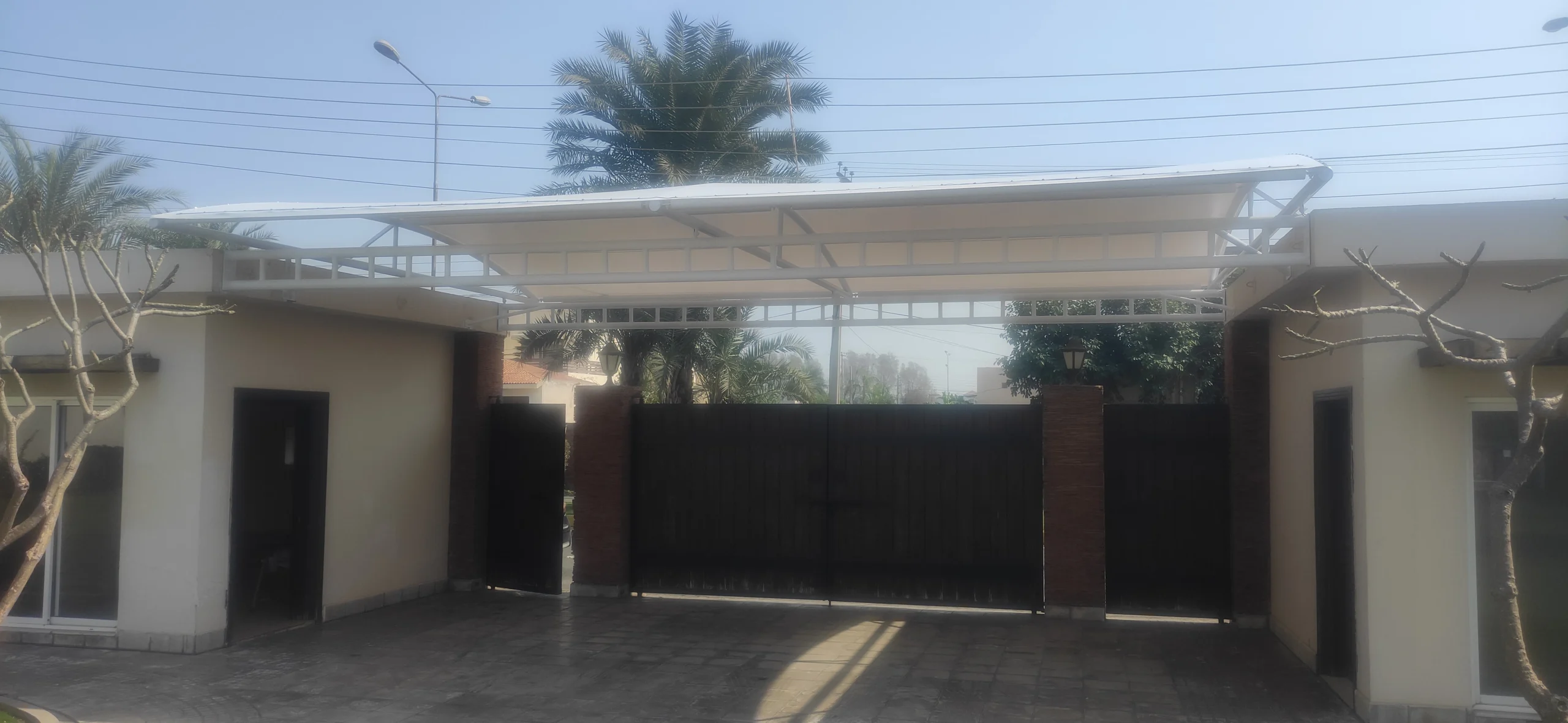 Gate Entrance Shade Canopy (1) The Gate Entrance Shade is made of tensile fabric for entry doors, offering sun and rain protection with a durable and stylish design.