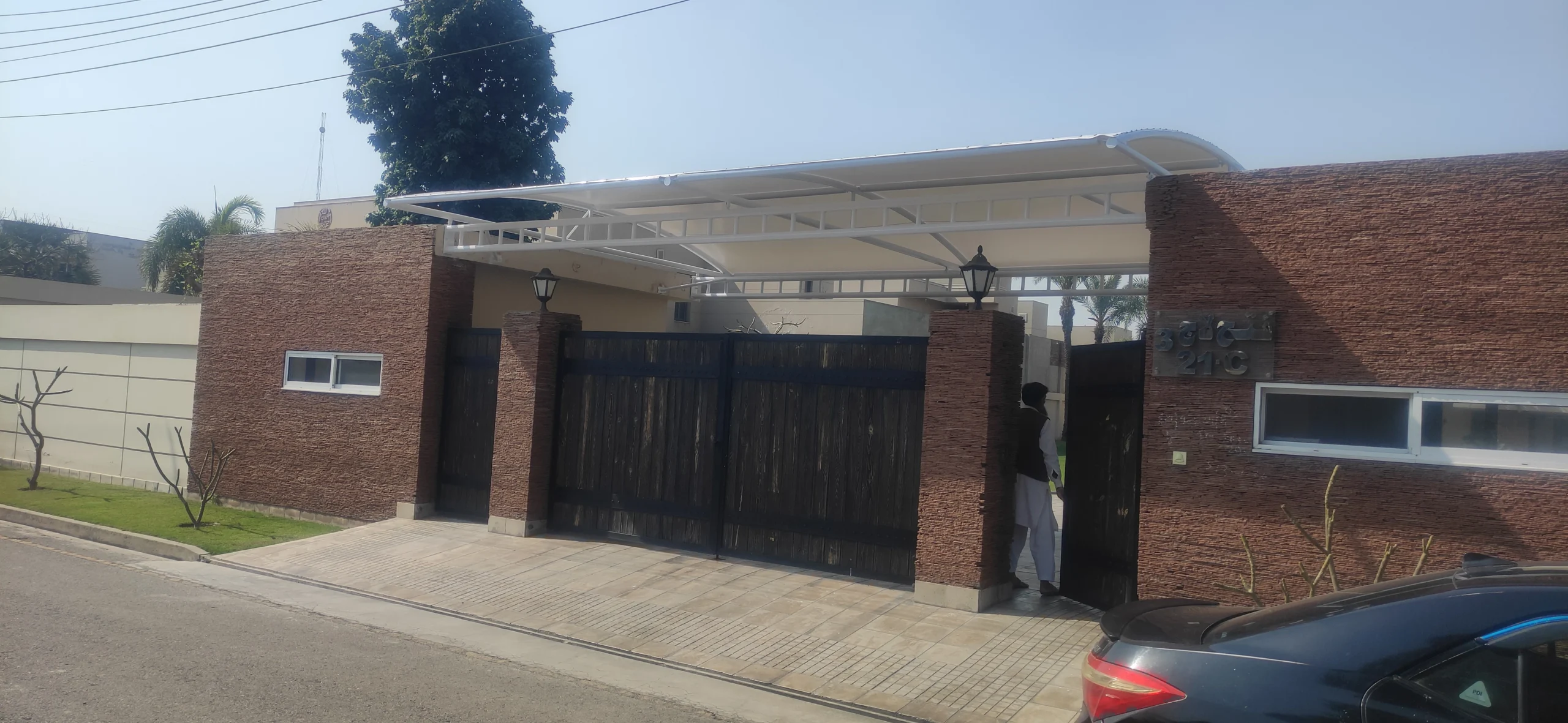 Gate Entrance Shade Canopy (2) The Gate Entrance Shade is made of tensile fabric for entry doors, offering sun and rain protection with a durable and stylish design.