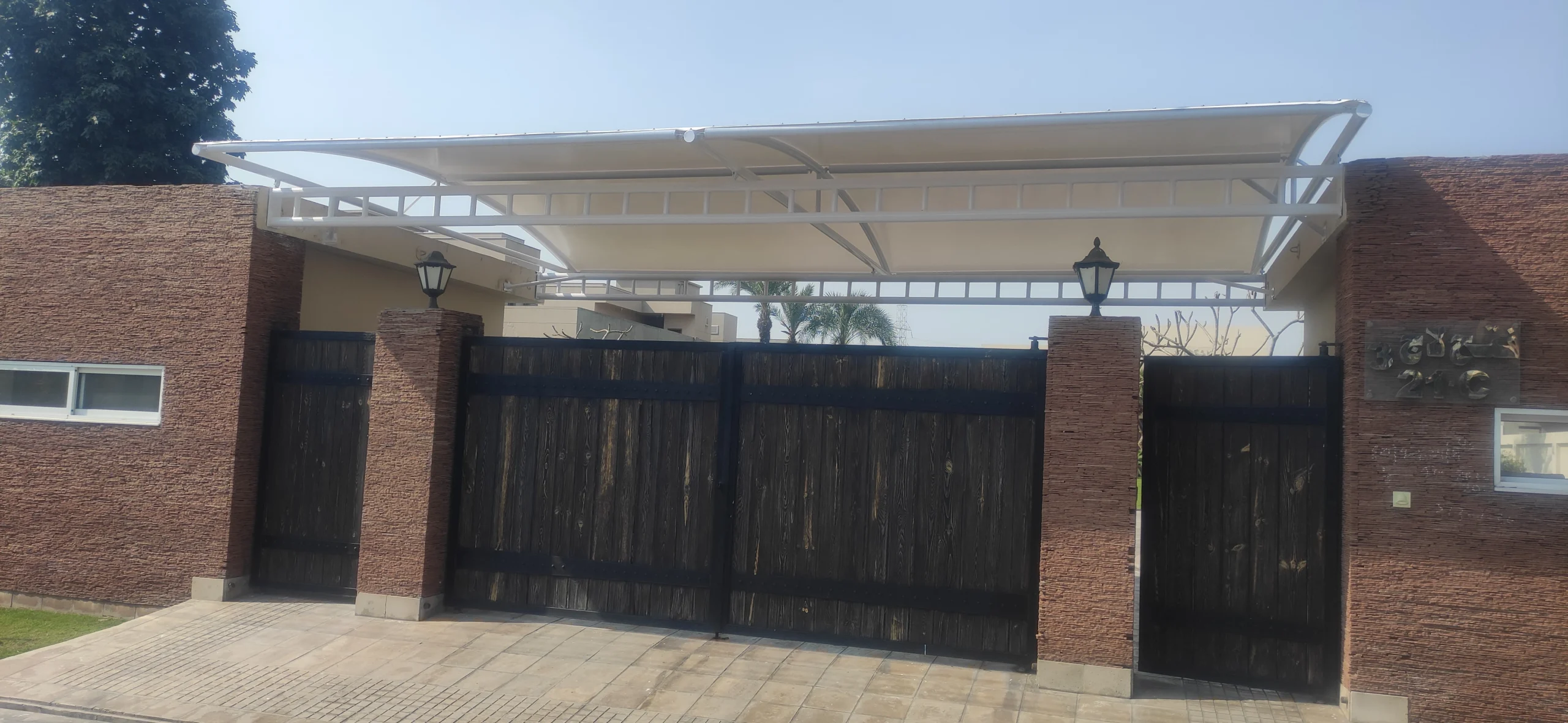 Gate Entrance Shade Canopy (3) The Gate Entrance Shade is made of tensile fabric for entry doors, offering sun and rain protection with a durable and stylish design.