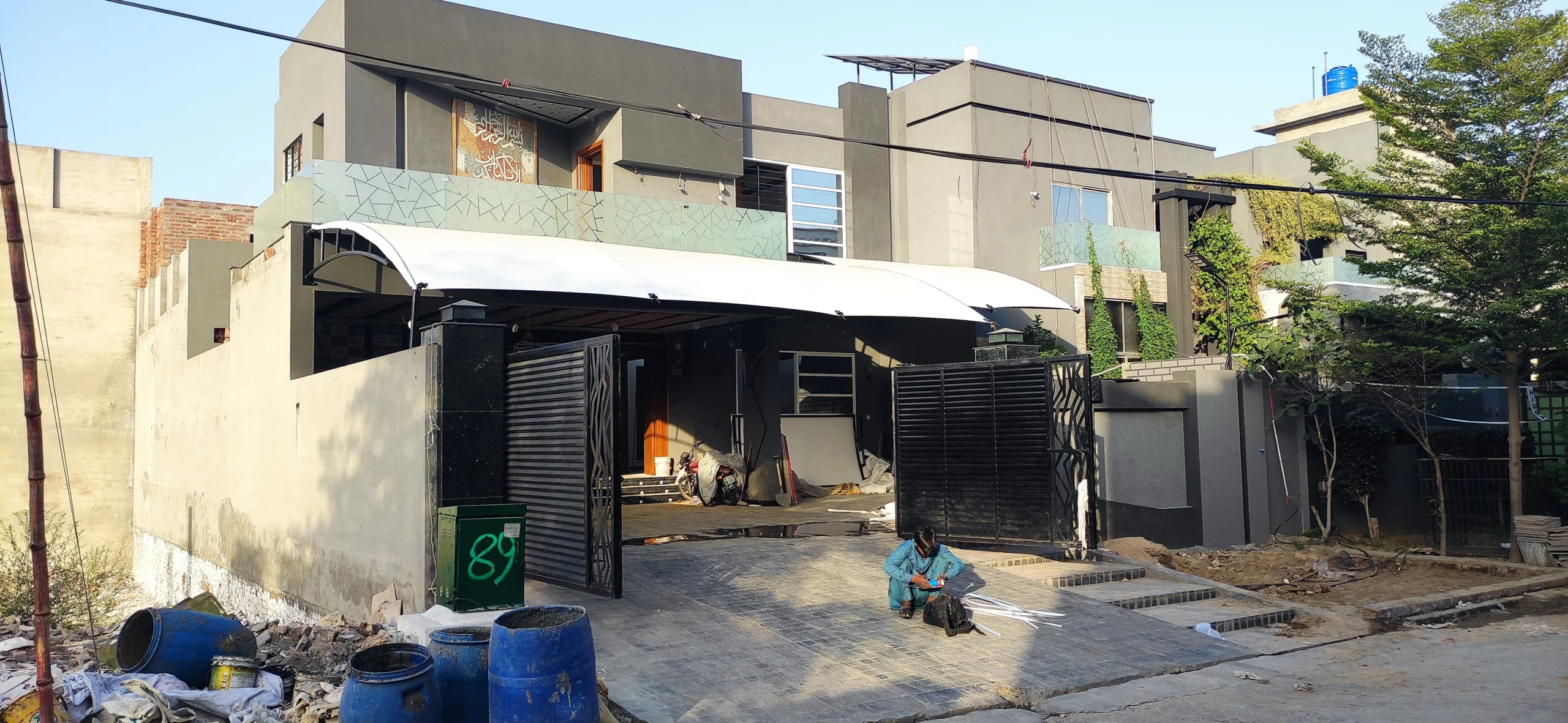 Home Front shade ideas in pakistan 2025 (2) Wall-mounted tensile fabric home front shade offering modern outdoor protection and style in Pakistan.