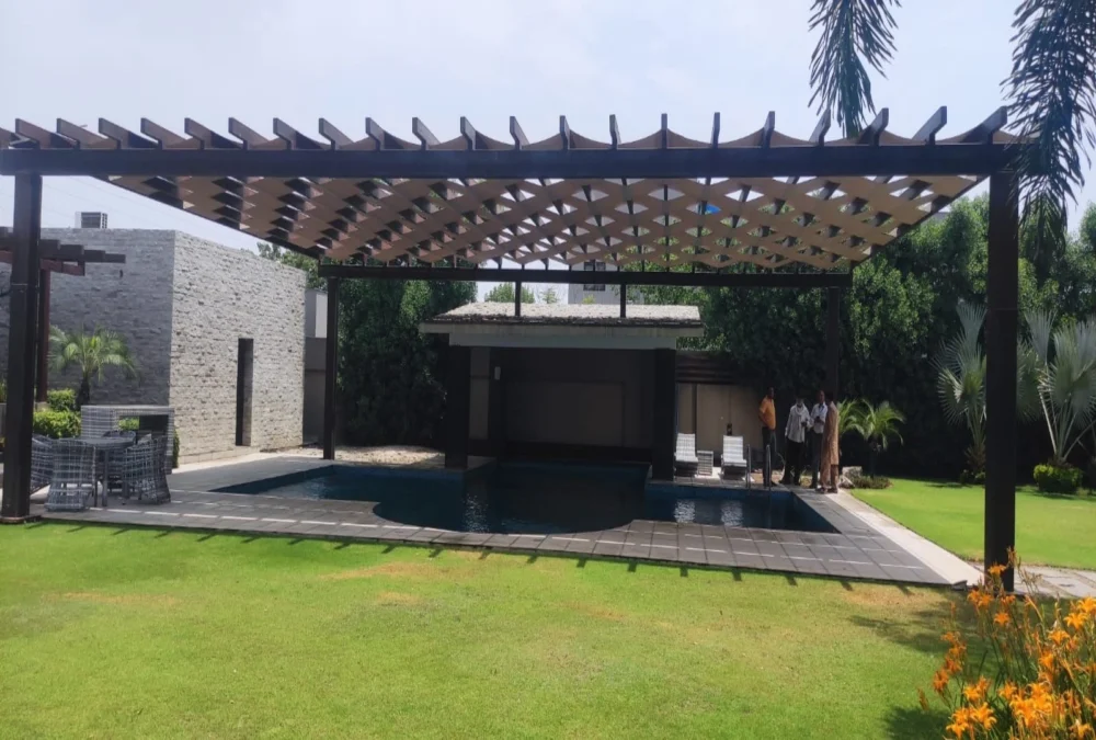 A modern pool pergola shade design featuring a stylish and durable structure, providing UV protection and enhancing outdoor aesthetics for swimming pool areas.