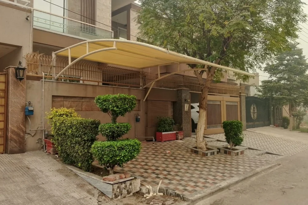 Tensile parking shed for cars – custom shade solution in Pakistan for residential and commercial use by Covers and Shades.