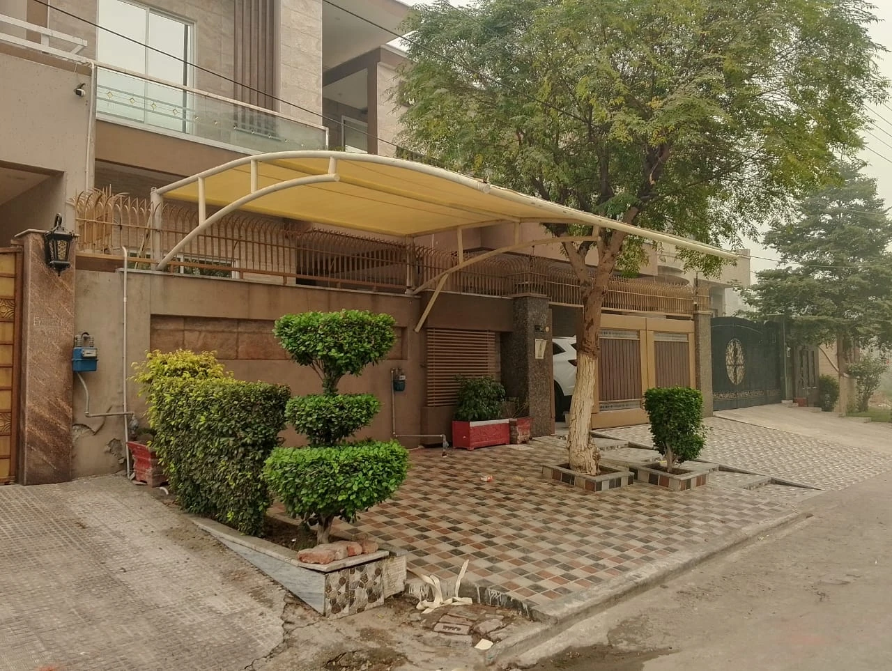 Tensile parking shed for cars – custom shade solution in Pakistan for residential and commercial use by Covers and Shades.